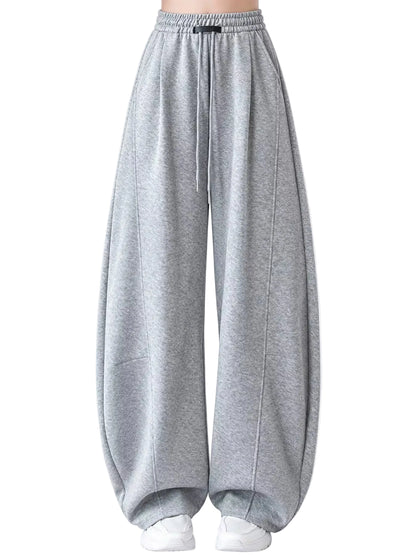 Light gray heathered wide-leg sweatpants with an elastic drawstring waist, shown on a model from the waist down against a plain white studio background.