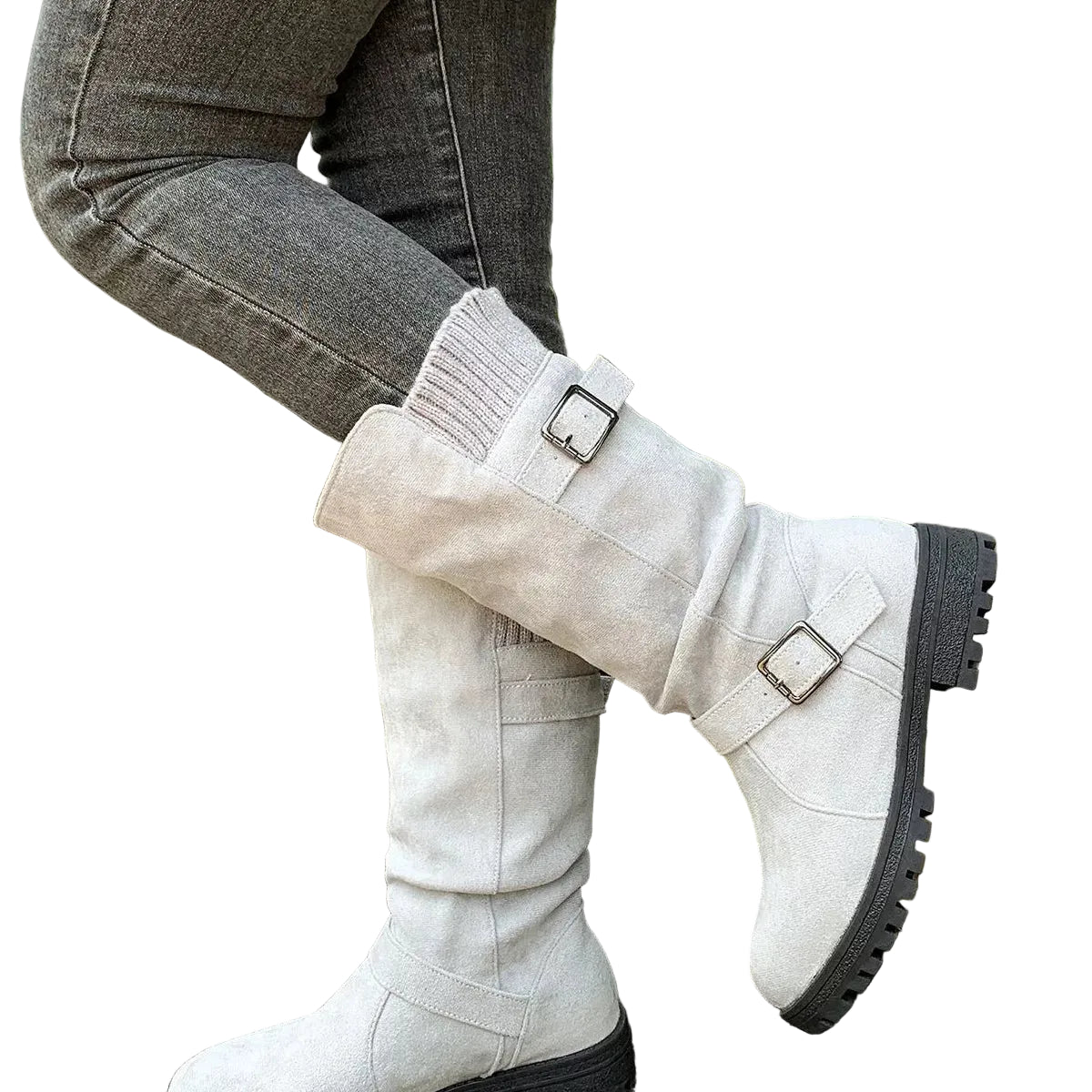 A person wearing off-white knee-high boots with dark gray soles and buckle straps, paired with gray jeans, sitting on weathered wooden steps outdoors.