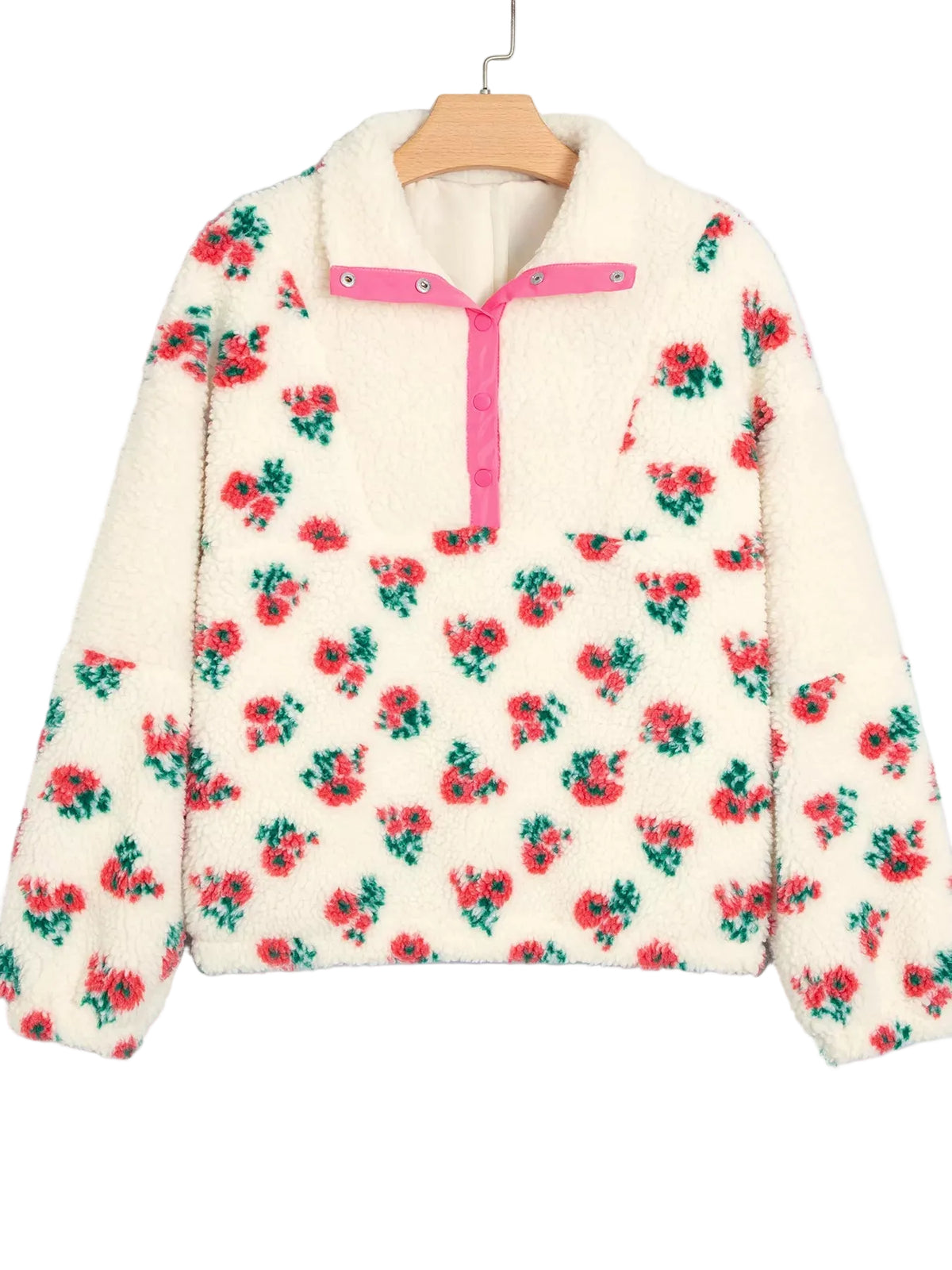 Cream sherpa fleece pullover sweater with a red and green floral print, featuring a pink zipper and collar trim, hanging on a wooden hanger against a light gray background.