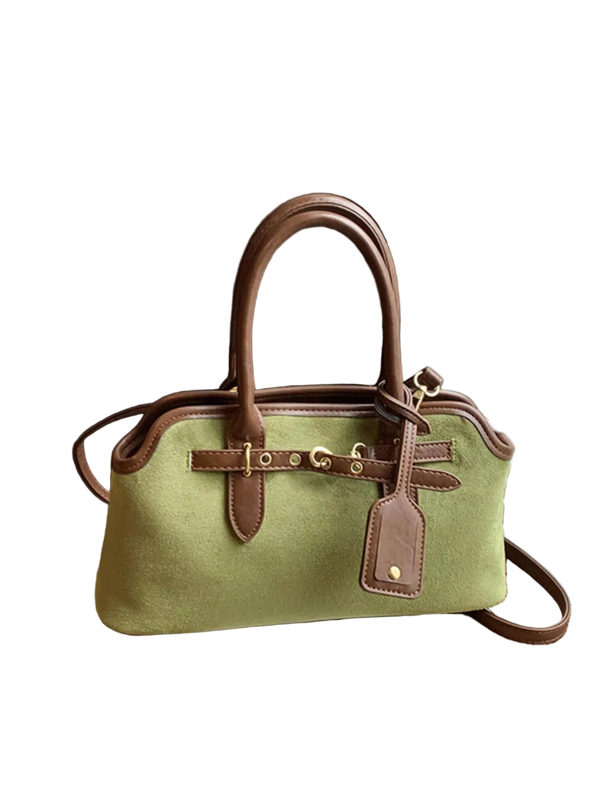 A structured light green canvas handbag with brown leather handles, trim, and hardware, resting on a wooden surface next to white window blinds.