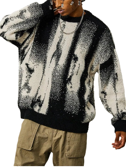 A person wearing a black and off-white textured fuzzy sweater with a vertical marbled pattern, paired with khaki cargo pants, against a plain gray studio background.
