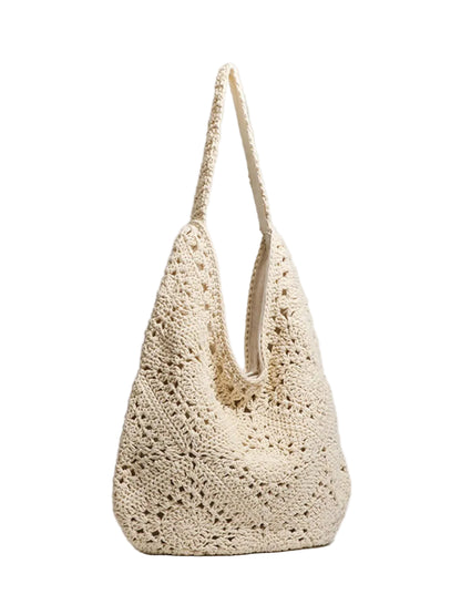 A cream-colored crochet shoulder bag with a textured openwork pattern and a single shoulder strap, photographed on a light gray background.
