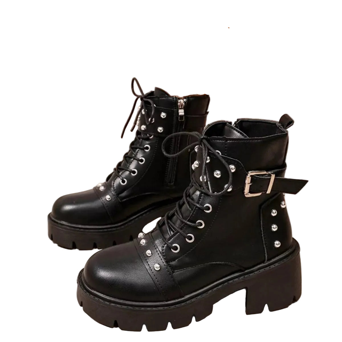 Black leather lace-up ankle boots with silver studs, buckle details, and chunky lug soles, shown on a model's feet against a beige background.