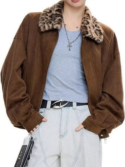 A person wearing a brown suede-like jacket with a leopard-print faux fur collar, layered over a light blue t-shirt and light-wash jeans.