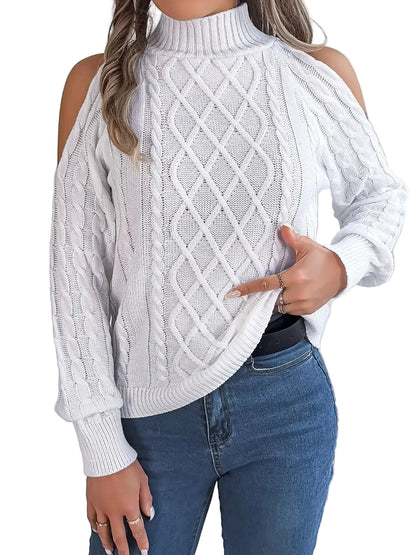 White cable knit sweater with cold shoulder design worn by a person, against a neutral background.