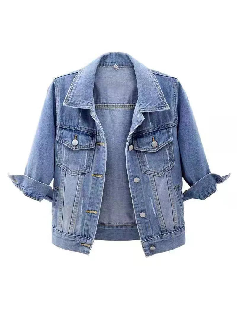 A light blue denim jacket with rolled-up sleeves, displayed on a light blue mannequin torso against a plain white background.