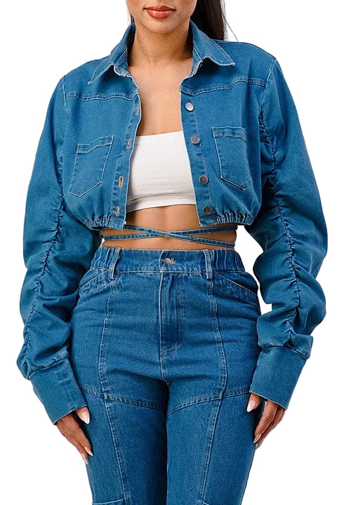 Person wearing a blue denim jacket and jeans on a white background