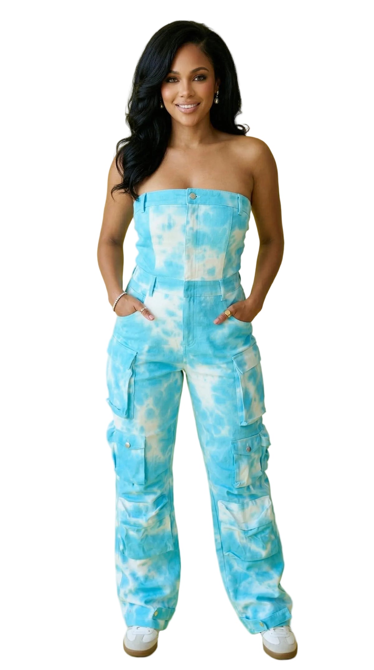 Woman wearing a blue tie-dye strapless jumpsuit on a yellow background