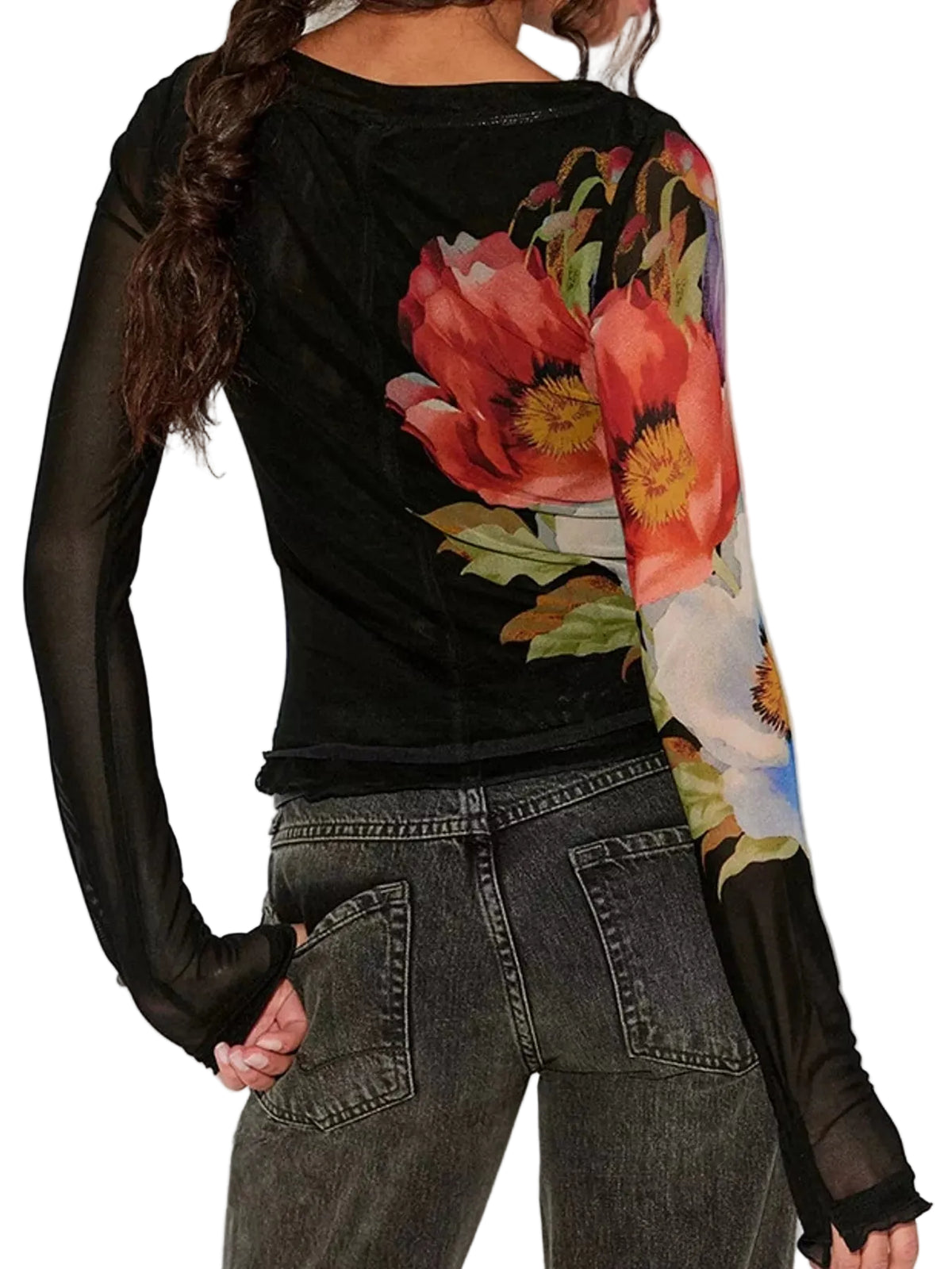 A woman wearing a black long-sleeve top with a large colorful floral print on the back and one sleeve, paired with dark gray jeans against a plain white background.