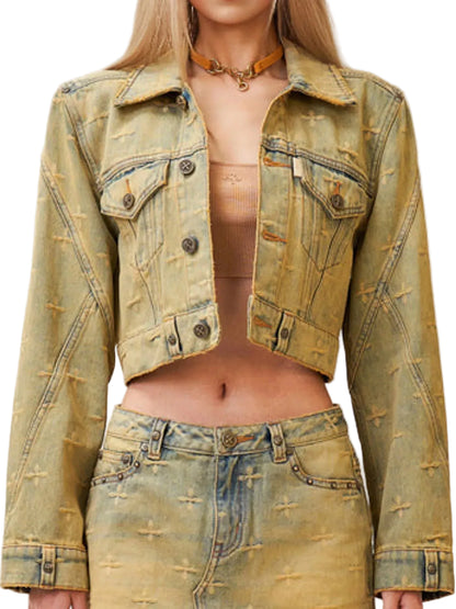 A cropped, distressed denim jacket in a faded olive-tan wash, styled on a model with matching distressed jeans and a beige tube top.