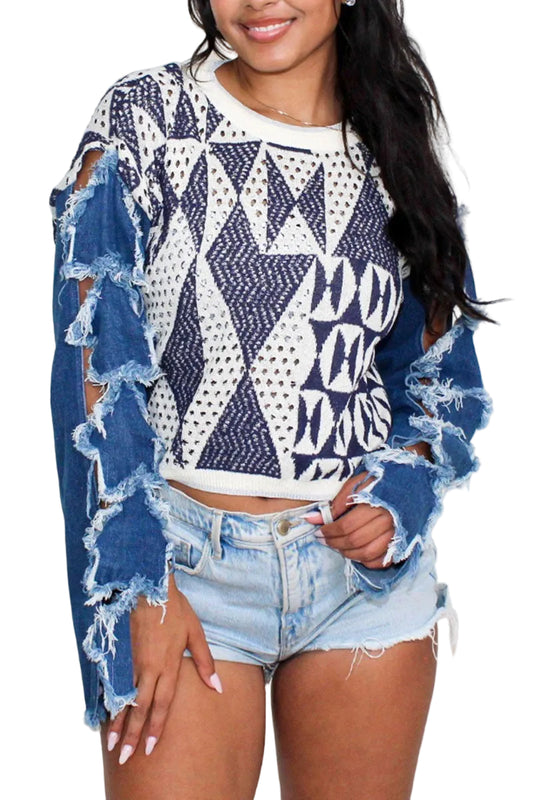 Woman wearing a patterned sweater with ripped denim sleeves and shorts on a white background