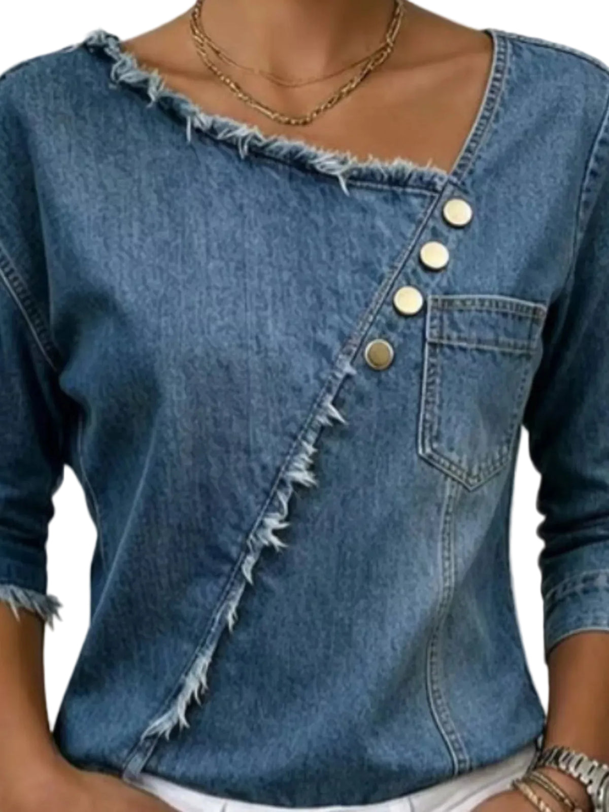 A close-up of a woman wearing a blue denim top with a diagonal buttoned seam, frayed edges, and a chest pocket.