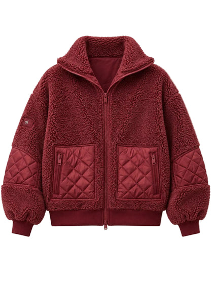 A deep red fleece zip-up jacket with quilted details on the pockets and sleeves, shown flat against a light beige background.