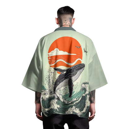 Person wearing a light green kimono-style shirt with a whale design on the back against a gray background