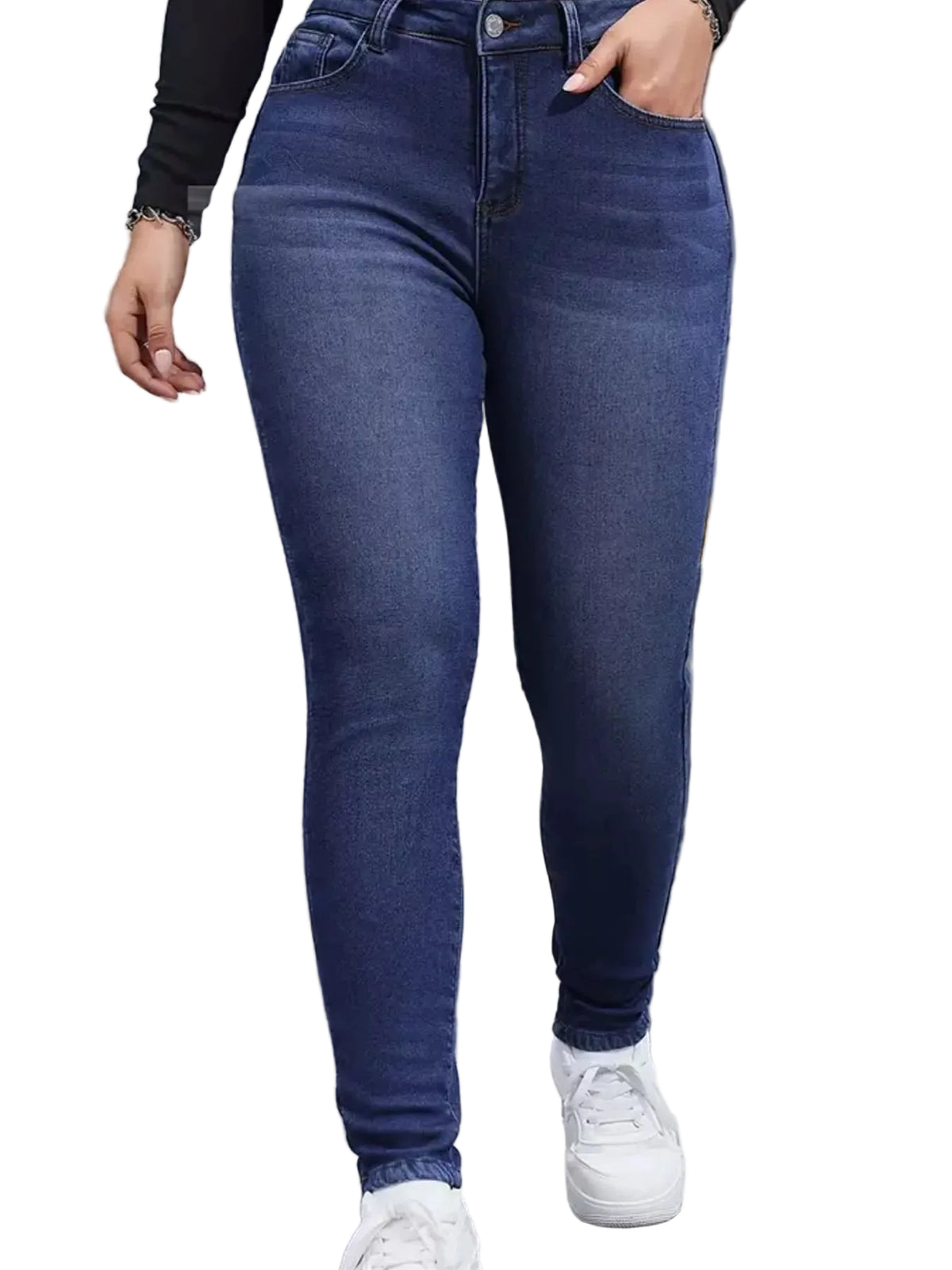 A person wearing dark blue skinny jeans with white sneakers, standing in front of a gray metal shutter door. A flame graphic is edited onto the pavement in the lower right corner.