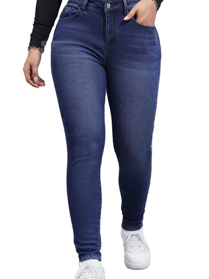 A person wearing dark blue skinny jeans with white sneakers, standing in front of a gray metal shutter door. A flame graphic is edited onto the pavement in the lower right corner.