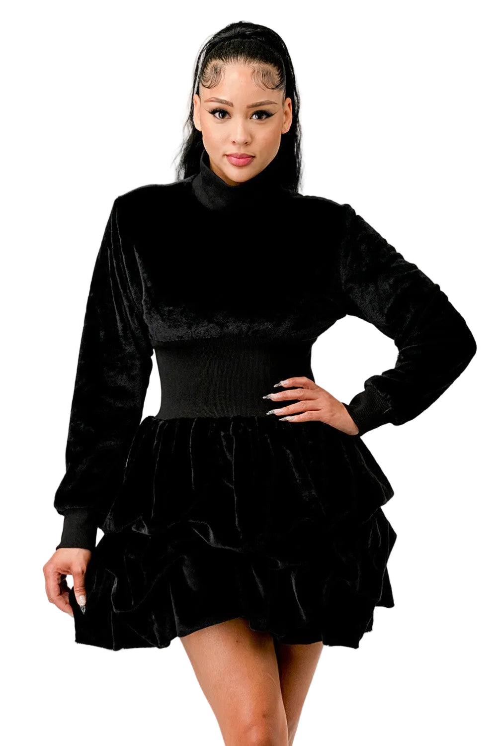 Woman wearing a black velvet dress against a plain background