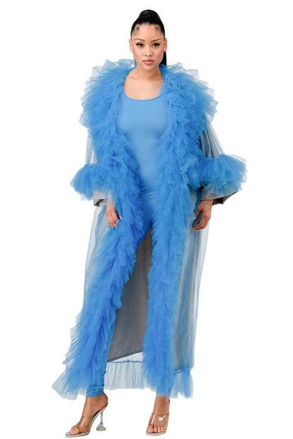 Woman wearing a blue outfit with a feathered jacket on a white background