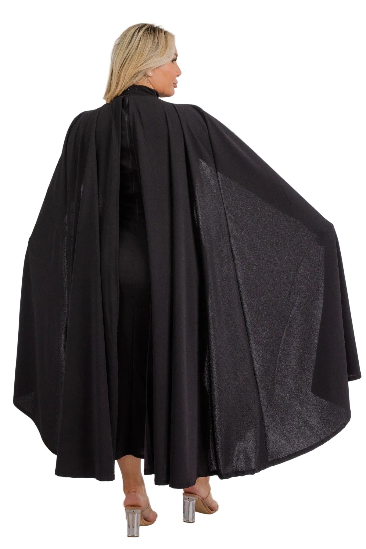 Woman wearing a black cape against a white background