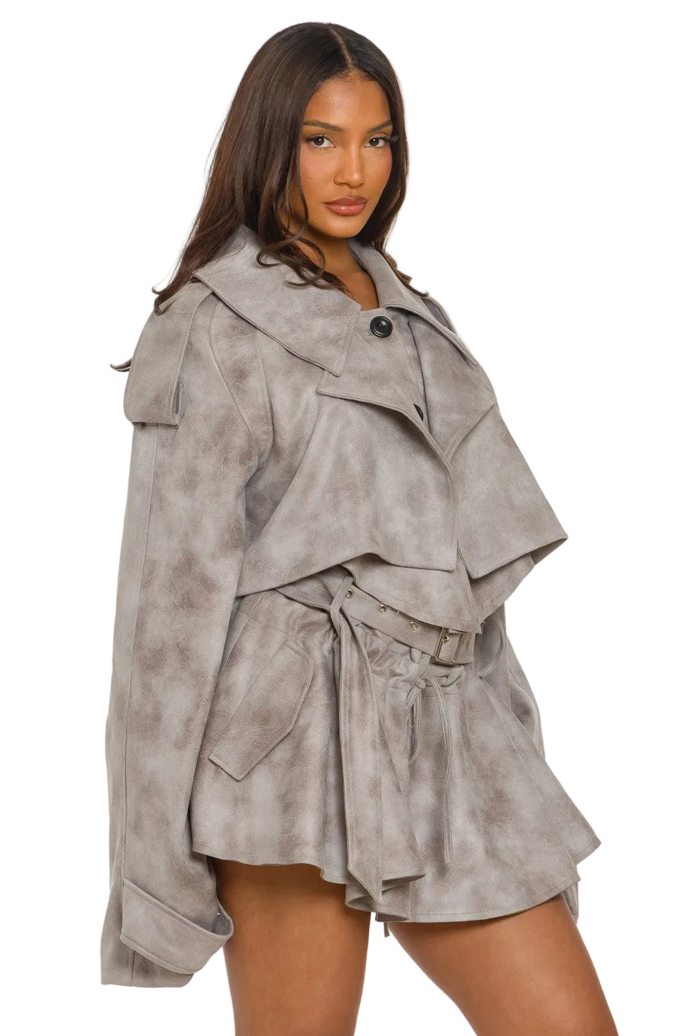 Woman wearing a layered suede outfit on a white background