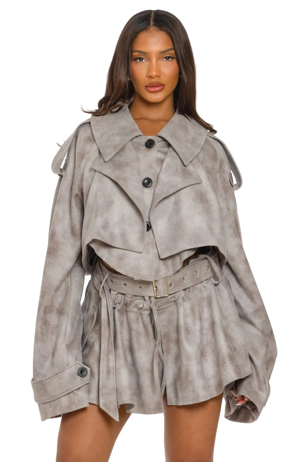Woman wearing a gray suede jacket and shorts set on a white background