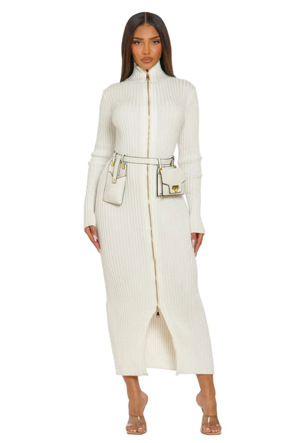 Woman wearing a long cream coat with a matching handbag on a white background