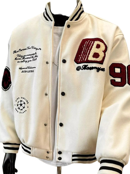 An off-white varsity-style jacket with black and navy striped ribbed collar, cuffs, and hem, featuring custom embroidered details including a large red and beige letter 'B' on the chest, black text, and the number 96 on the sleeve.