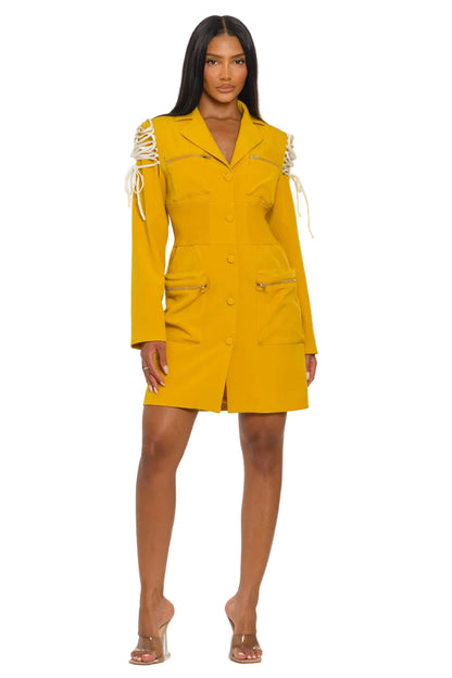 Woman wearing a yellow dress with white accents on a white background