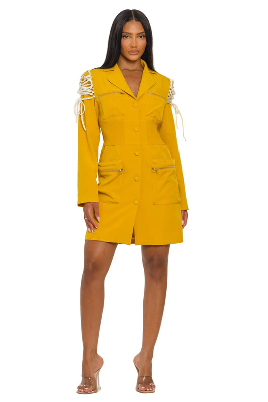 Woman wearing a yellow dress with white accents on a white background