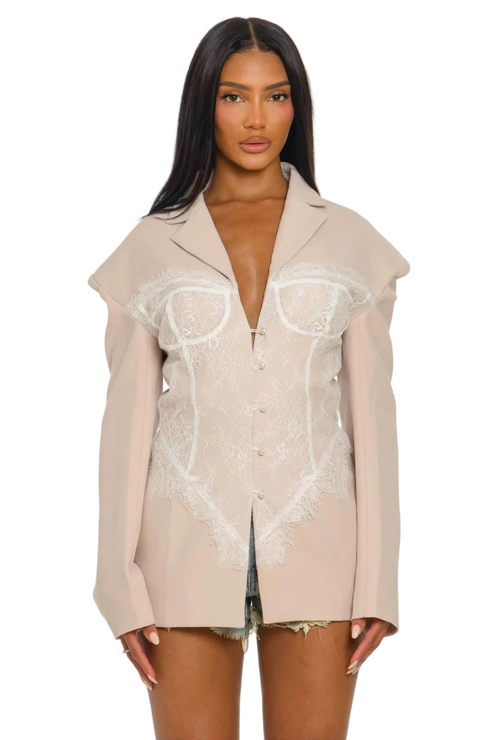 Woman wearing a beige shirt with lace detailing on a white background