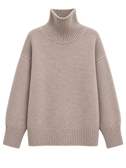 A light taupe knit turtleneck sweater with ribbed collar, cuffs, and hem, displayed on a clean off-white background.