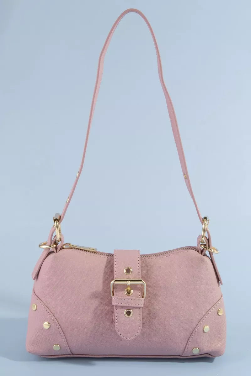 Pink handbag with gold accents on a light blue background