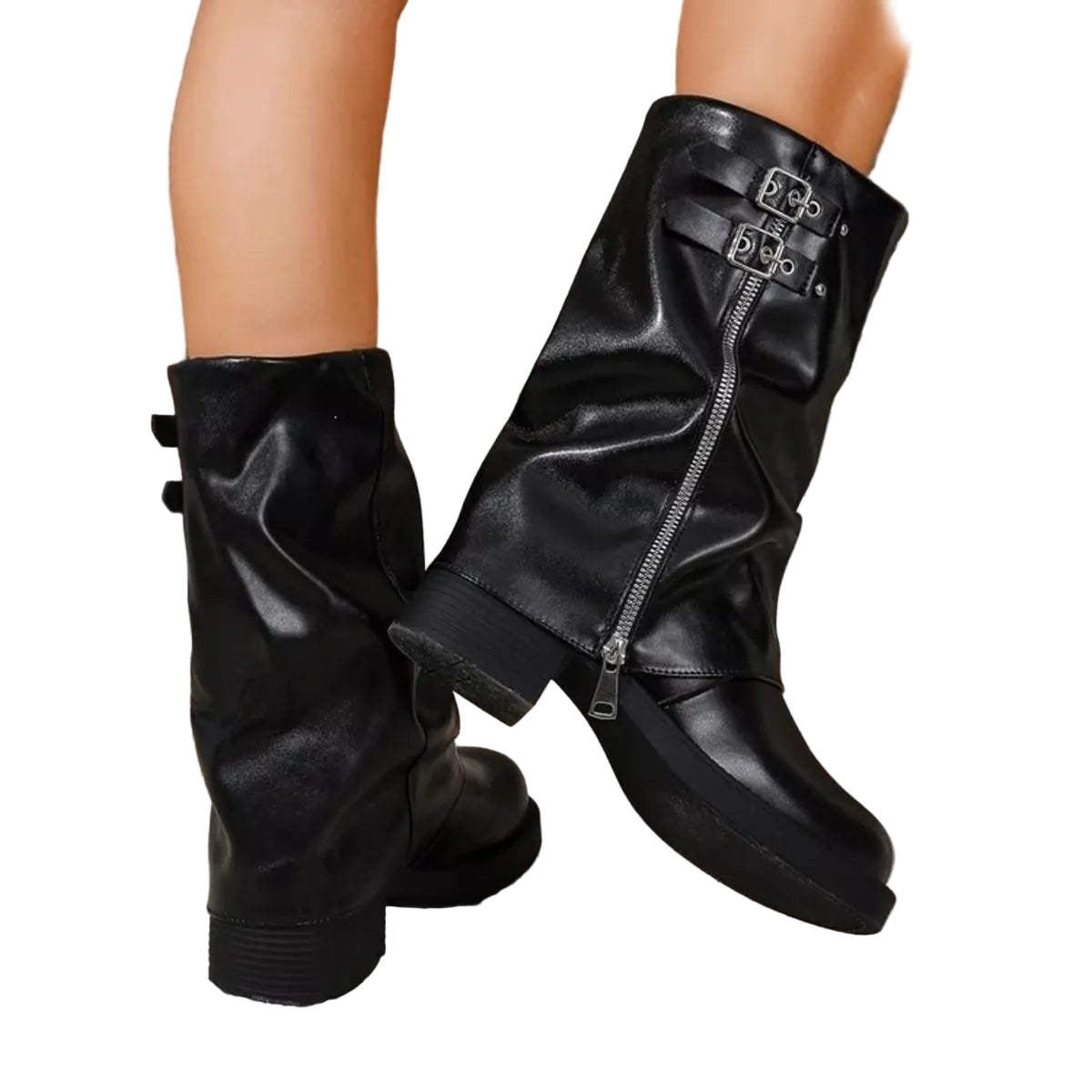 A pair of black faux-leather mid-calf boots with a side zipper and double buckle strap detail, shown on a mannequin or model's legs against a textured gray wall and stone floor.