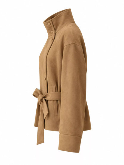 A tan suede belted jacket with a high stand collar, shown from a side profile view on a plain white background.