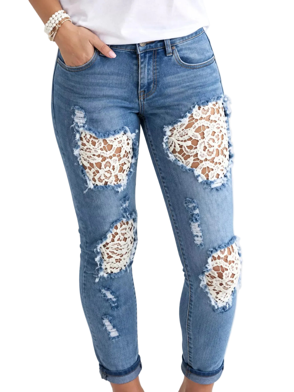 Light wash blue denim jeans with distressed rips and large white lace applique patches on the thighs and knees, shown on a model against a white background.