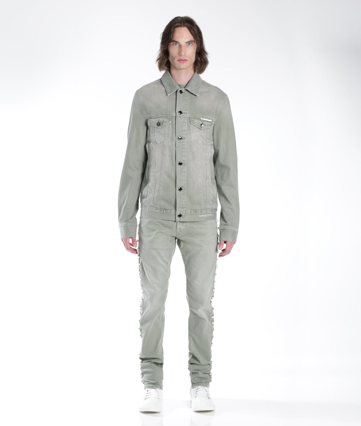 Person wearing a gray denim outfit on a white background