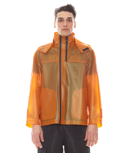 Person wearing a transparent orange raincoat with visible branding on a white background