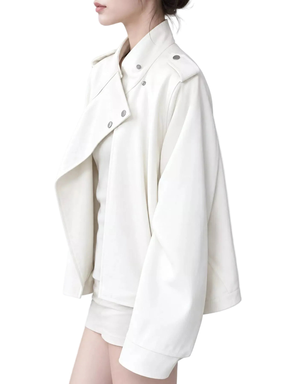 A woman wearing an oversized off-white faux leather jacket with silver snap details, shown from the side against a light gray background.