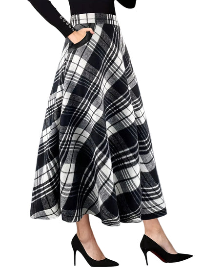 Person wearing a black and white plaid skirt with high heels on a blurred street background
