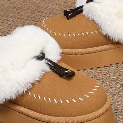 Plush faux fur-lined platform slippers with tassel detail