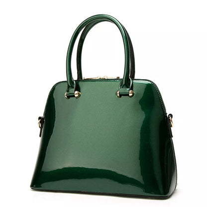 Green handbag with gold accents on a white background