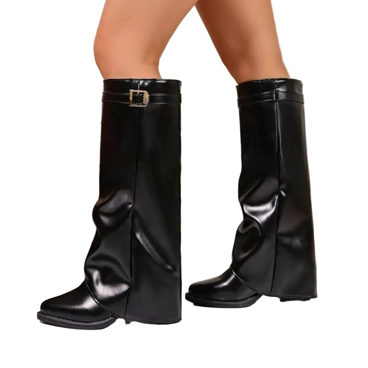 A pair of black faux-leather knee-high boots with a buckle detail on the side, shown on a model's feet in an indoor setting.