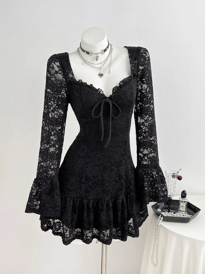 A black lace long-sleeve mini dress with a sweetheart neckline, ruffled trim, and a front tie, displayed on a white mannequin. The dress features intricate floral lace patterns throughout.