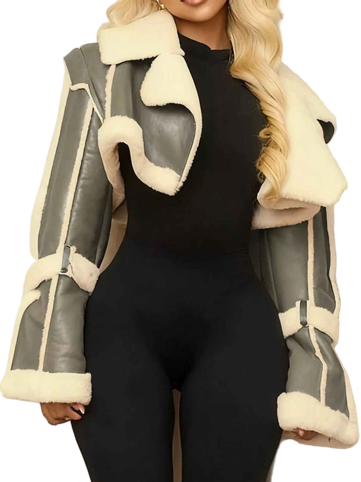 A woman wearing a cropped shearling-style jacket with gray faux-leather panels and cream fleece trim over a black bodysuit, shown against a light curtain background.