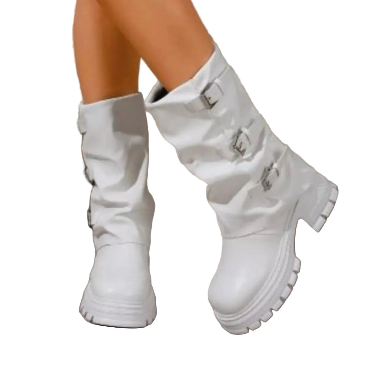A pair of white mid-calf boots with chunky lug soles and silver buckle details, shown on a model's feet against a stone wall background.