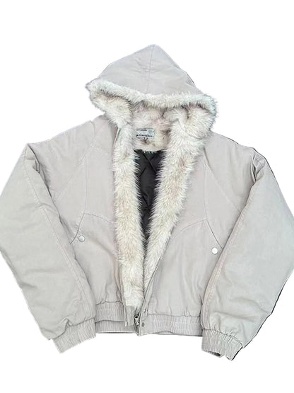 A light beige hooded jacket with a thick cream faux-fur trim, laid flat on a dark asphalt surface.