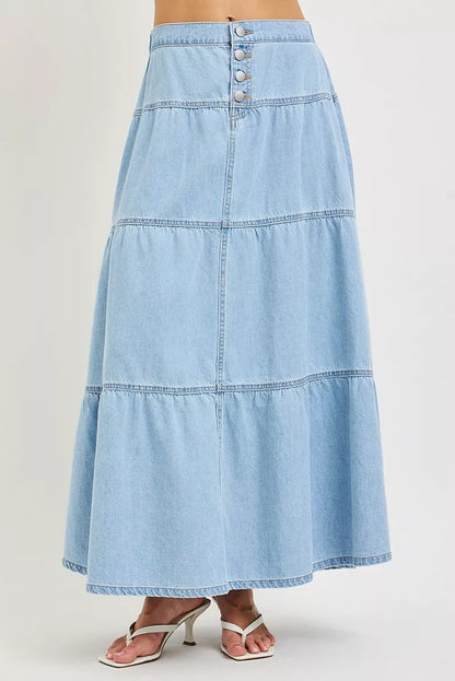 Light blue denim skirt on a plain background