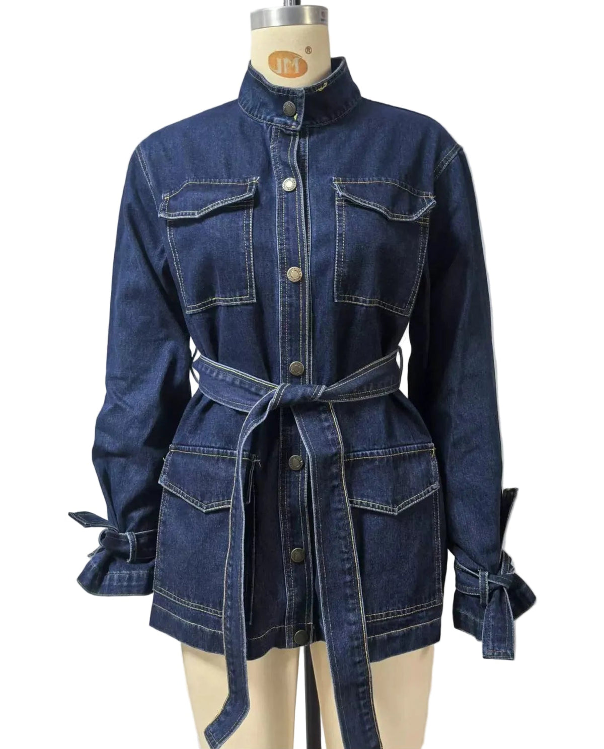 A dark blue denim long-sleeve shirt jacket with a matching tie belt, displayed on a cream-colored dress form mannequin against a light gray wall.