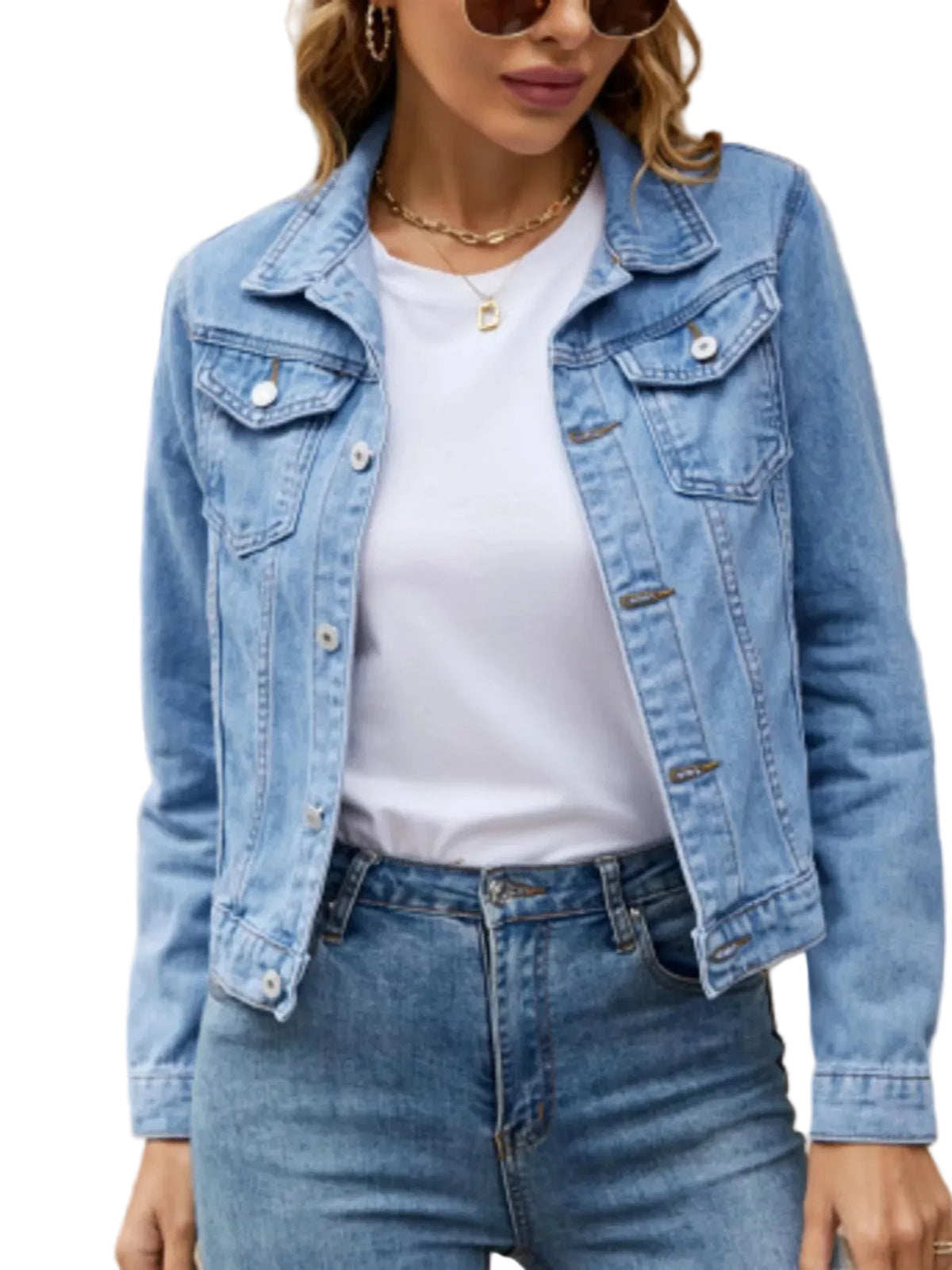 Person wearing a light blue denim jacket and jeans in front of a building with text.