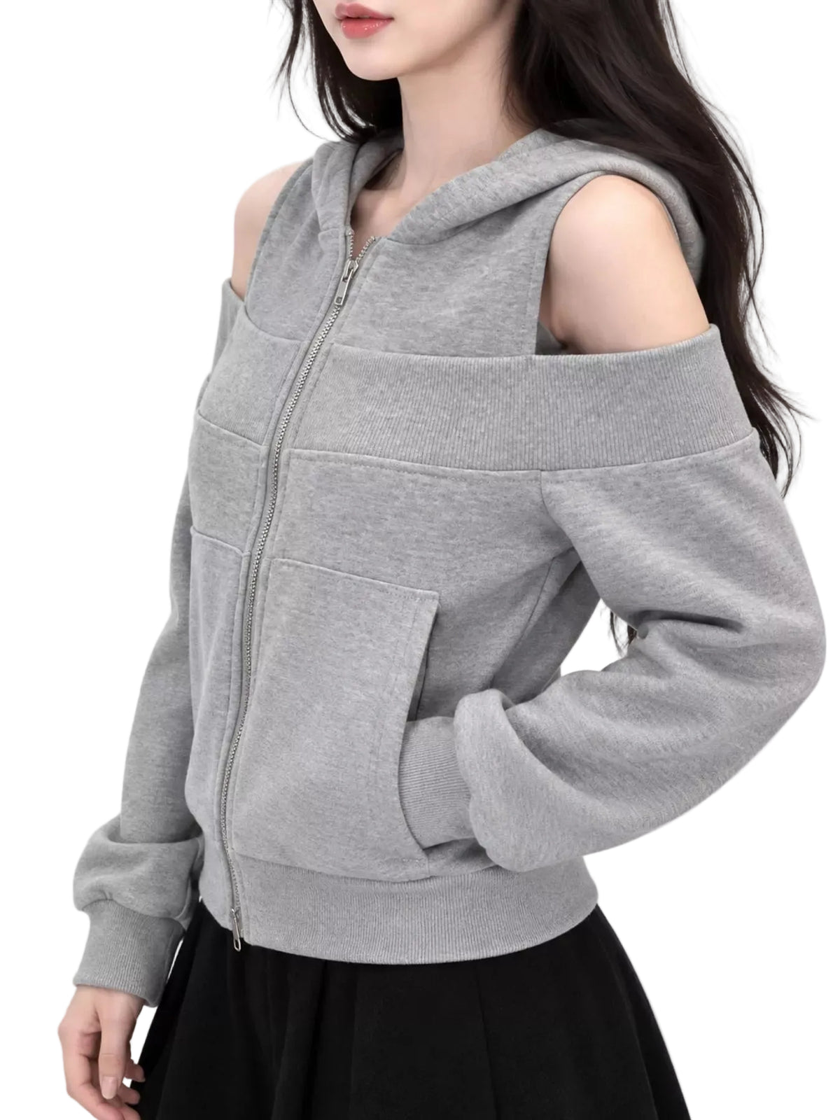 A woman wearing a light gray off-the-shoulder zip-up hoodie with a front pocket, paired with a black skirt, against a plain light gray background.